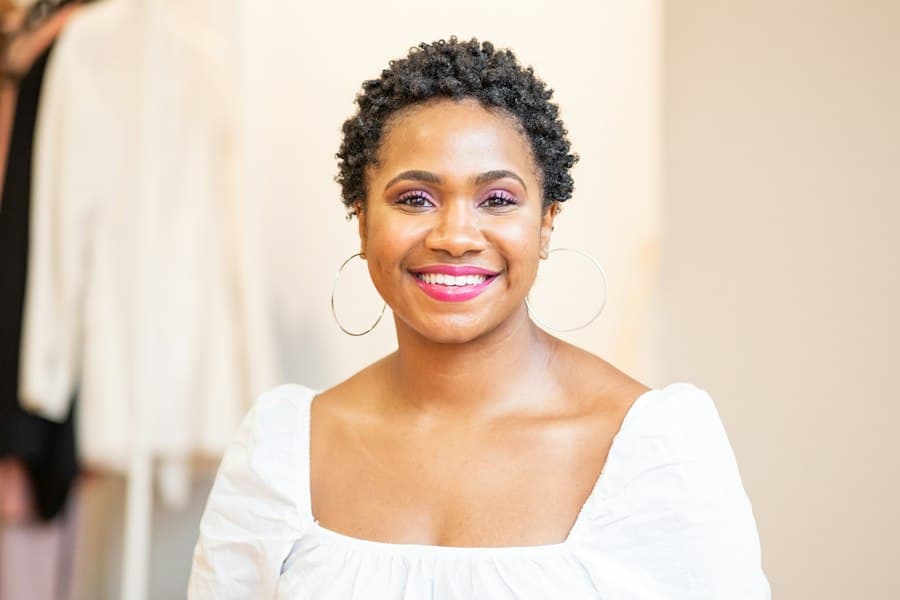 Illustrative portrait of a smiling woman in a white blouse, used for a sample speaker profile.