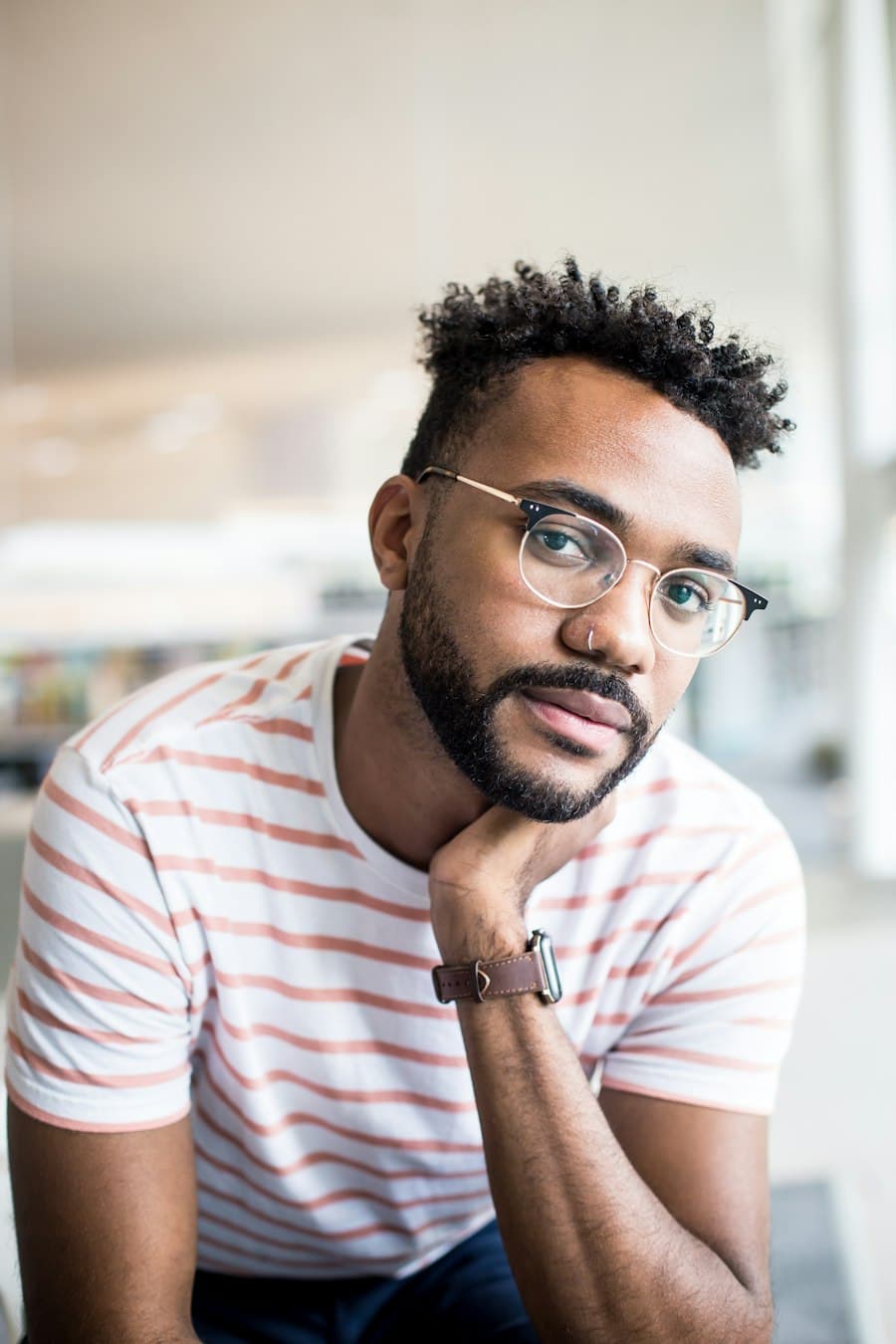 Illustrative portrait of a man with glasses resting his chin on his hand, used for a sample speaker profile.